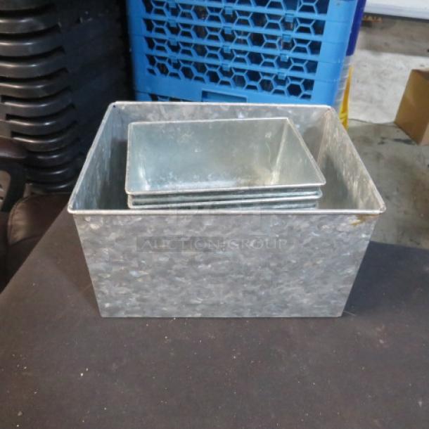 Assorted galvanized boxes in various sizes, stackable. Used condition with visible weathering. Ideal for storage or decor.