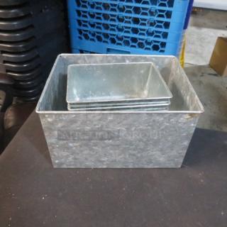 Assorted galvanized boxes in various sizes, stackable. Used condition with visible weathering. Ideal for storage or decor.