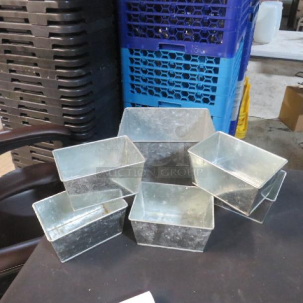 Assorted galvanized boxes in various sizes, set of six. Features durable metal construction, ideal for storage.