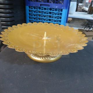Gold 12-inch round pastry display stand with scalloped edges, intricate detailing, and sturdy base. Like-new condition.
