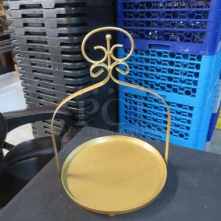 Gold display stand with ornate top design, circular base, in excellent condition. Ideal for showcasing items or decorative use.