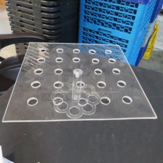 Clear acrylic holder with multiple circular cutouts, square base, and central column. Excellent condition.