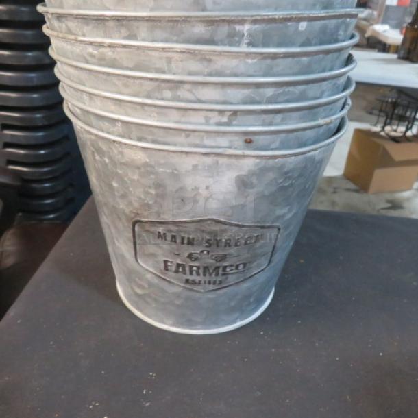 7.5x6 galvanized bucket with "Main Street Farm Co" label. Durable, rustic style, great for decorative use or storage.