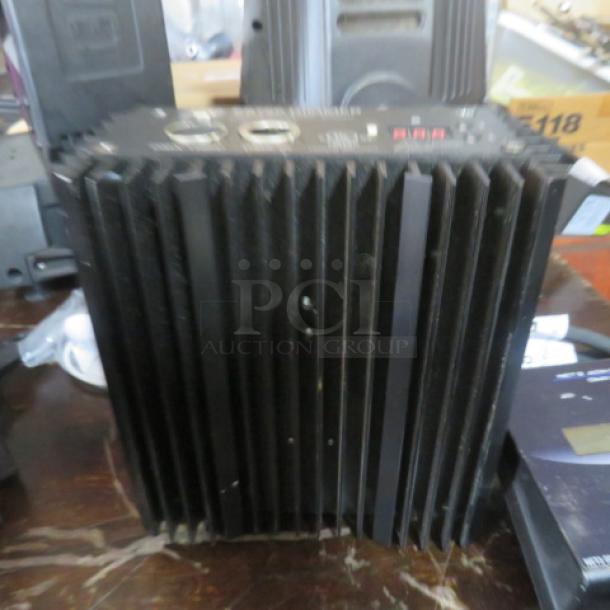 ETC ES 750 Dimmer, 120/230 Volt, black with ribbed design, minor wear. Features control panel and ventilation.