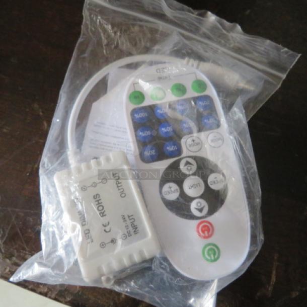 New LED dimmer with remote control, DC12-24V, in packaging. Features adjustable brightness settings.