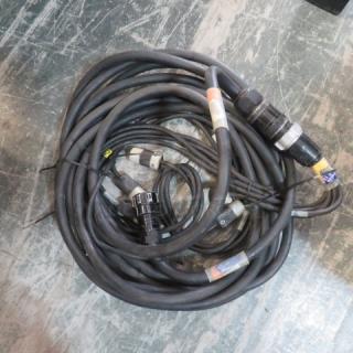 A collection of coiled black lighting cords with various connectors, some have colored tape markings. Gently used condition.
