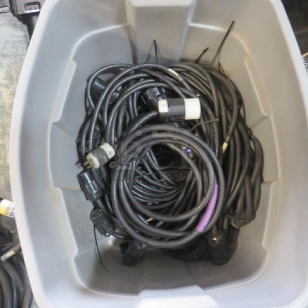 Box of assorted lighting cords, various lengths and connectors, coiled, in used condition.