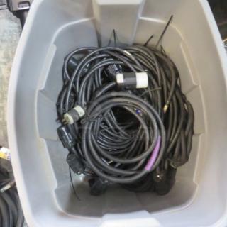 Box of assorted lighting cords, various lengths and connectors, coiled, in used condition.
