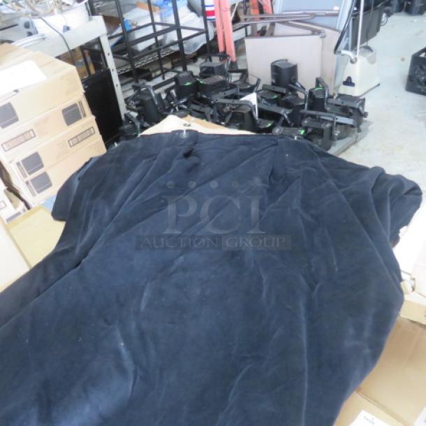 One lot of 5 heavy-duty flame-retardant black velvet stage curtains, dimensions 6ft x 11.9ft, shown in storage area.