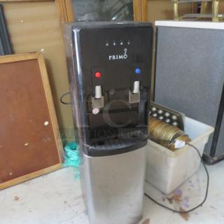 Primo Water Cooler, Model 601144; 115 Volt, dimensions 12x13x41 inches. Black and silver, dual spouts, power cord visible.