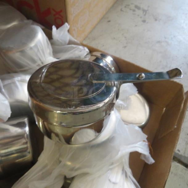 New stainless steel chafer fuel holders in bulk lot, featuring a sleek design and durable construction, ideal for catering.