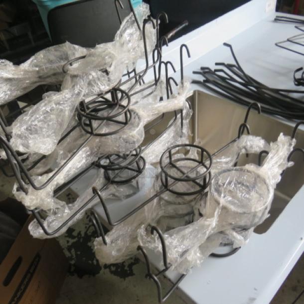 Lot of black metal chafer fuel holders, wrapped in plastic, used condition. Ideal for catering or event use.