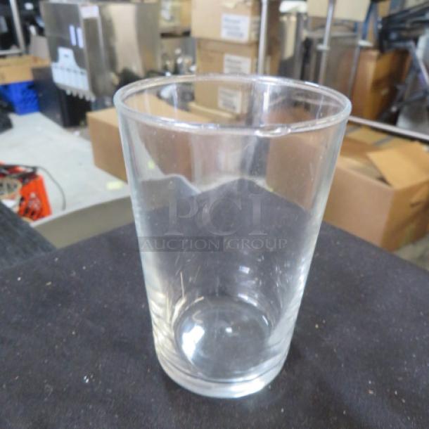 Clear Flight Glass, model 12XBID, in good condition. Cylindrical shape, standard size, set on a black surface.