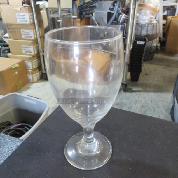 Clear stem water glass, 12XBID model, good condition. Simple design with a rounded bowl and sturdy base. No visible tags.