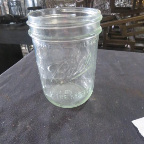 Wide Mouth Pint Mason Jar featuring embossed "Ball" branding. Clear glass, good condition, ideal for collectors or use.