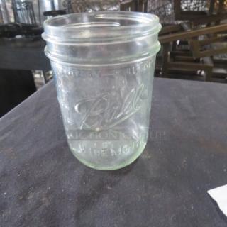 Wide Mouth Pint Mason Jar featuring embossed "Ball" branding. Clear glass, good condition, ideal for collectors or use.