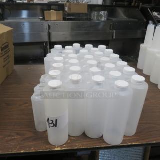 Assorted new squeeze bottles on table, varying sizes, white caps, one marked "431" with visible label.