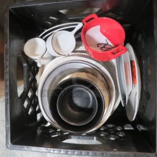 A lot of miscellaneous kitchenware in a crate, including bowls, plates, and mugs. Some items have visible orange stickers.