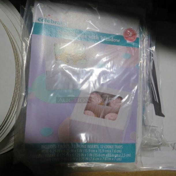 Pack of bakery paper items; includes Celebrate It! cupcake boxes with window, inserts, and cookie trays. New condition.