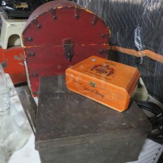 A collection of miscellaneous items including a red vintage chest, a wooden cigar box labeled "Short Story," and a metal box marked "Patented."