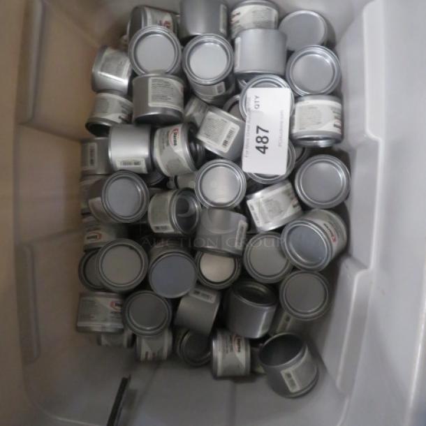 Alt text: Large container filled with numerous small cans of Sterno fuel, labeled "Lot 487." Each can appears new and sealed.