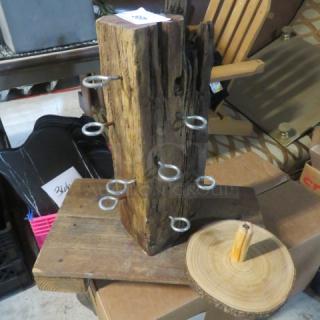 Assorted wooden decor featuring a rustic wooden stand with ring hooks and a circular wooden base. Appears in used condition.