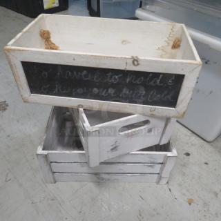 Assorted wooden decor boxes with rustic white finish, chalkboard fronts, handles, and varying sizes; slightly distressed condition.