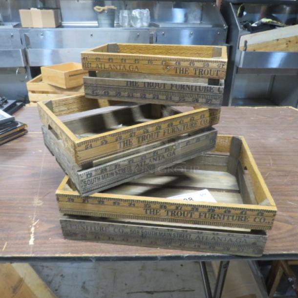 Assorted vintage wooden decor boxes with "The Trout Furniture Co." branding. Stacked set of three, used condition.