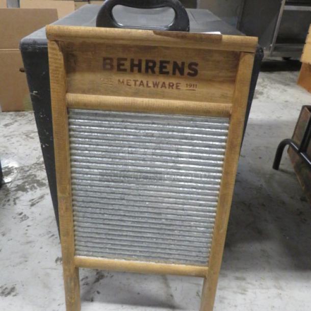 Wooden washboard with metal scrubbing surface, branded "Behrens Metalware 1911," in good condition.