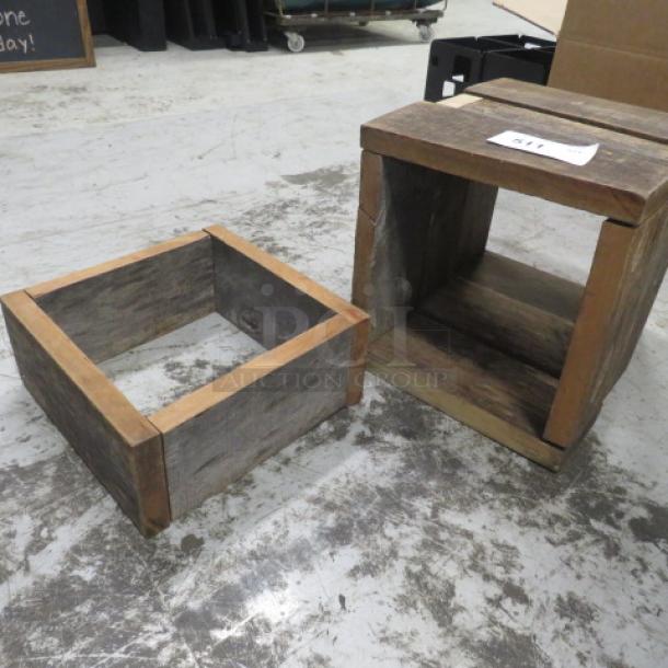 Wooden risers, rustic finish, square shape. One has a partial bottom and the other is fully enclosed. Tag reads "4XBID".