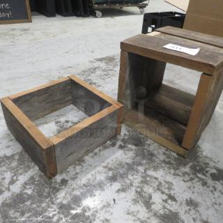 Wooden risers, rustic finish, square shape. One has a partial bottom and the other is fully enclosed. Tag reads "4XBID".