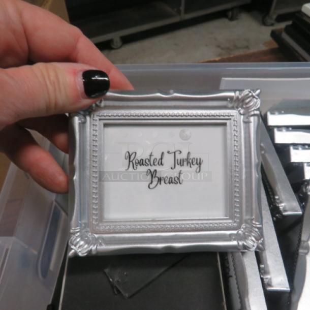 Silver picture frame with ornate design, labeled "Roasted Turkey Breast," held by a hand. Part of a large lot.