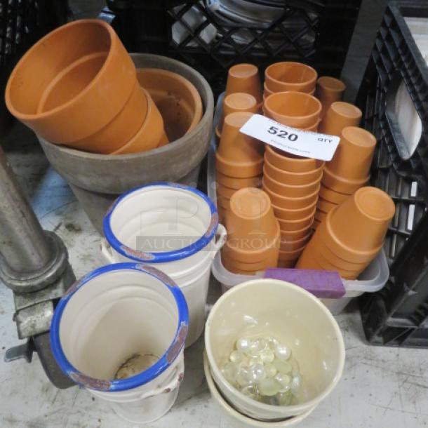 Assorted lot of terracotta and ceramic pots; includes stack of terracotta pots, painted rim pots, and glass marbles in bowl.