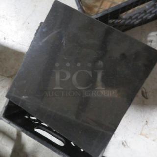 Lot of approximately 18 black marble tiles, each 12x12 inches. Smooth finish, subtle veining, slight surface wear.