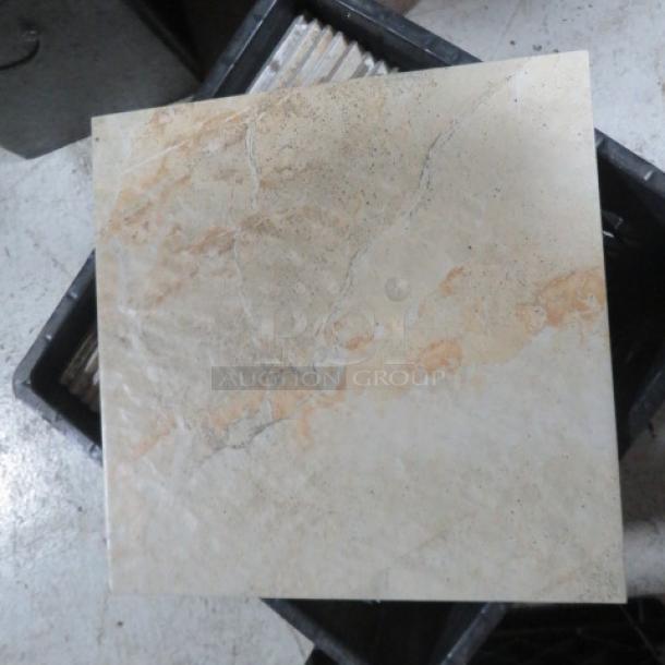 One lot of approximately 28 beige 12x12 tiles with a natural stone pattern, displayed in a storage bin.