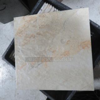 One lot of approximately 28 beige 12x12 tiles with a natural stone pattern, displayed in a storage bin.