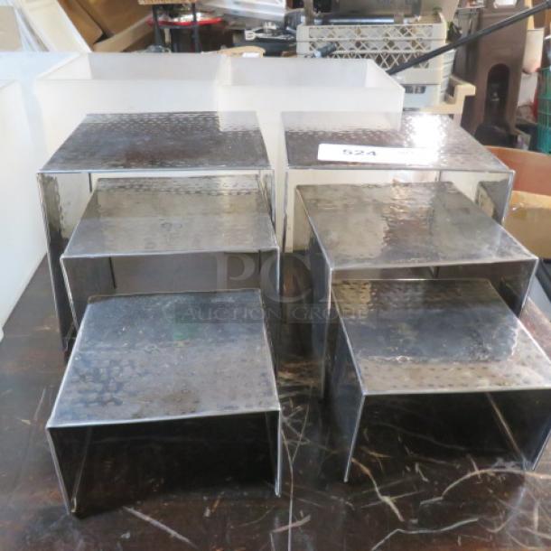 Hammered silver display stands set of six, assorted sizes, textured finish, excellent condition, ideal for retail or exhibitions.