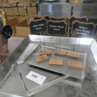 Lot of catering display stands with wooden bases and chalkboard labels reading "Apple Stuffed Chicken," "Bourbon Glazed Salmon," and "Honey & Thyme Roasted Vegetables." Item number 526 visible.