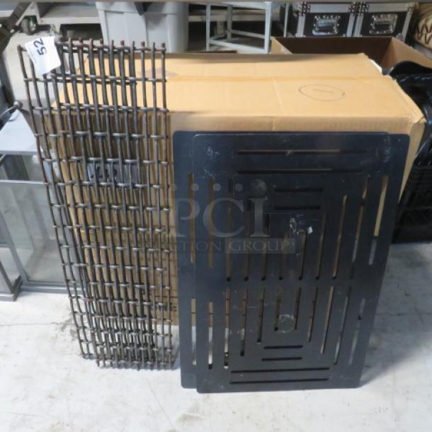 One lot of miscellaneous items including metal grills and a cardboard box, some wear visible, ideal for various uses.