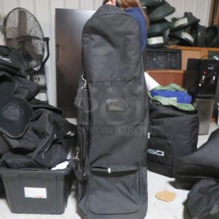 QSC equipment bag on wheels, black, durable fabric, metal zippers, front pocket, used condition, brand label visible.