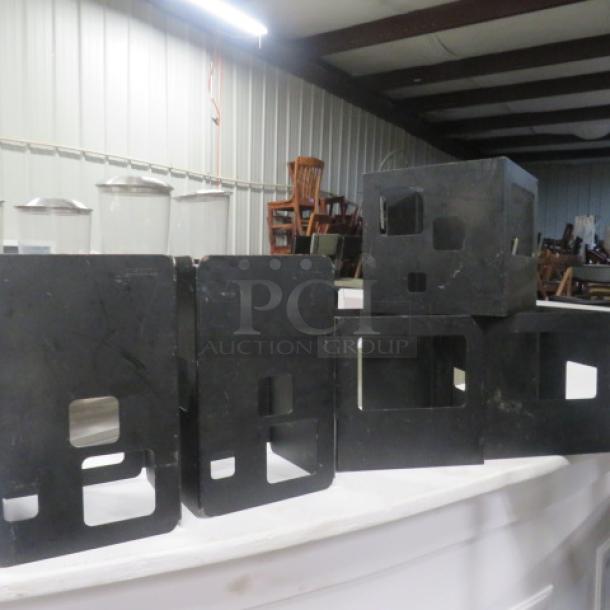 Assorted Rosetto brown metal risers, set of five, featuring cut-out designs. Good condition, suitable for display purposes.