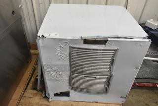 Brand new Scotsman MC1030MA-32A ice machine, 1077 lb capacity, 208/230V, with dents on sides, label showing "2 QTY".