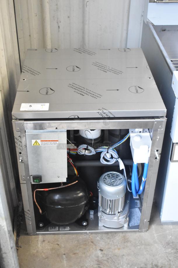 Brand new Manitowoc RNP0620A-161 nugget ice machine, 591 lb capacity, 115V, 1 phase. Visible dent on corner. Inside components shown.