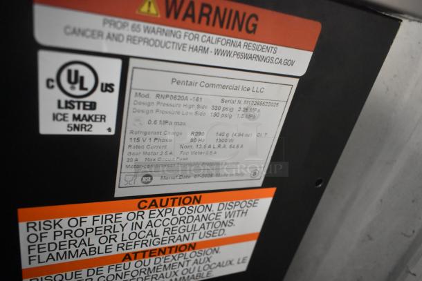 Label on Manitowoc RNP0620A-161 nugget ice machine, 591 lb capacity, 115V 1 phase, showing warning and specs.