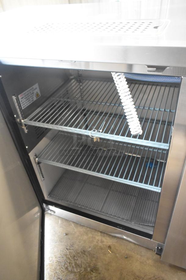 Brand new Avantco 178UDD60HCS stainless steel double tap kegerator, two 1/2 keg capacity, 115V, shows interior shelves.