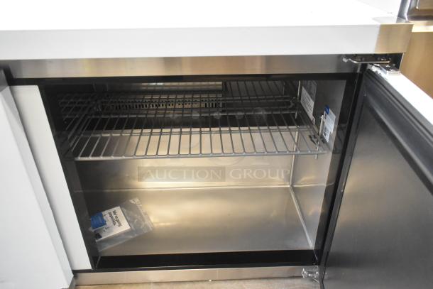 Avantco 178AU60R Commercial 2-Door Undercounter Cooler, scratch and dent, 115V, stainless interior, open door view.