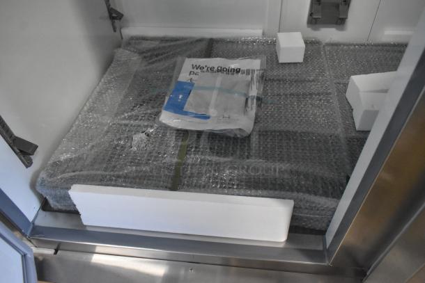 Brand new Avantco 178A49RHC 2023 commercial 2-door reach-in cooler, 115V, 1 phase, scratch and dent condition, packaging visible.