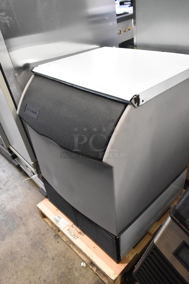 Brand new Ice-O-Matic ICEU220FA5 ice machine with 70 lb bin. Minor scratches visible. Model ICEU220FA5, 115V, 1 Phase.