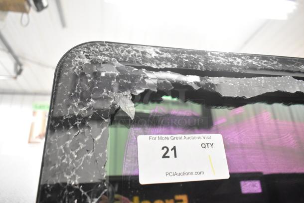 True CVM-27-HC merchandiser with LED lighting, broken glass visible. Auction tag reads "21 QTY."