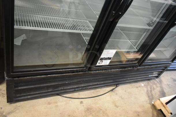 2019 True GDM-72-HC 3 Door Reach-In Cooler, 115V, 1 Phase, black exterior, clear glass doors, visible label, industrial setting.